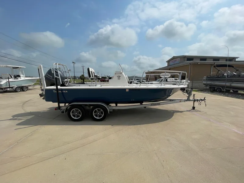 Slide: The Image of 2022 Tidewater 2110BM boat on trailer in sunny outdoor setting. - 7