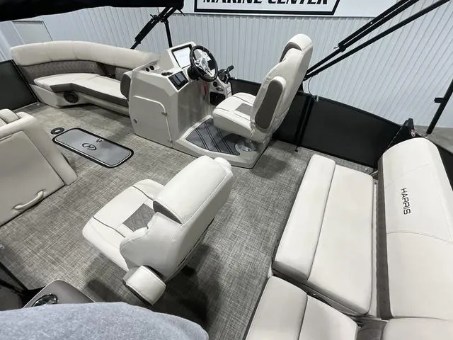 Slide: The Image of 2022 Harris SUNLINER 230 SLDH pontoon boat interior with beige seating and modern helm. - 10