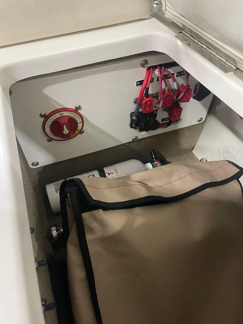 Slide: The Image of 2018 Cobalt R5 boat compartment with electrical panel and fire extinguisher. - 14