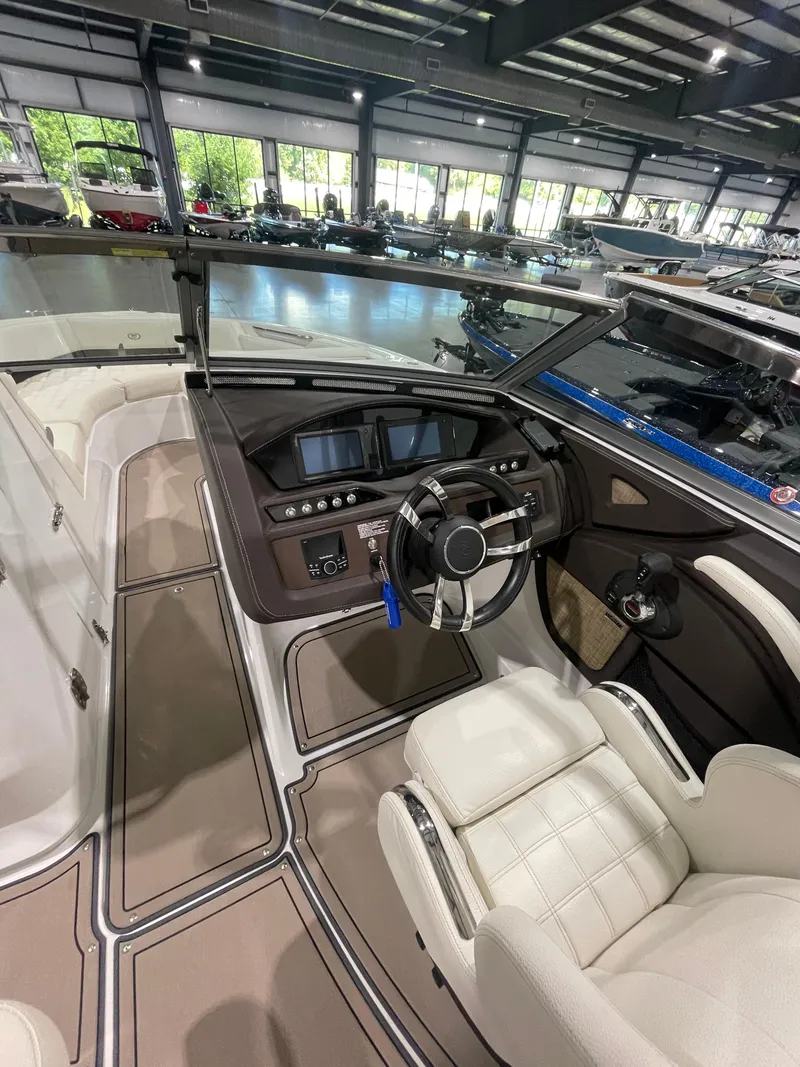 Slide: The Image of 2018 Cobalt R5 boat interior with modern dashboard and steering wheel in showroom. - 17