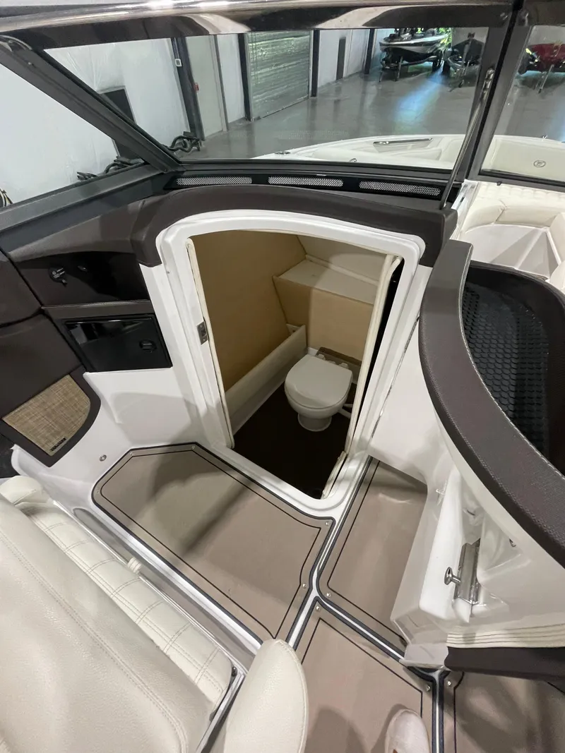 Slide: The Image of 2018 Cobalt R5 boat interior with compact bathroom and seating area. - 20