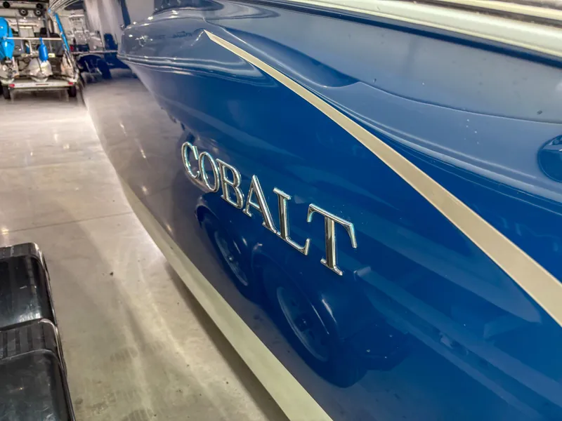 Slide: The Image of 2018 Cobalt R5 boat, blue exterior, parked indoors. - 3