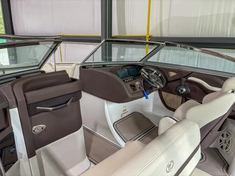 Slide: The Image of Interior of a 2018 Cobalt R5 boat, featuring a sleek dashboard and comfortable seating. - 7