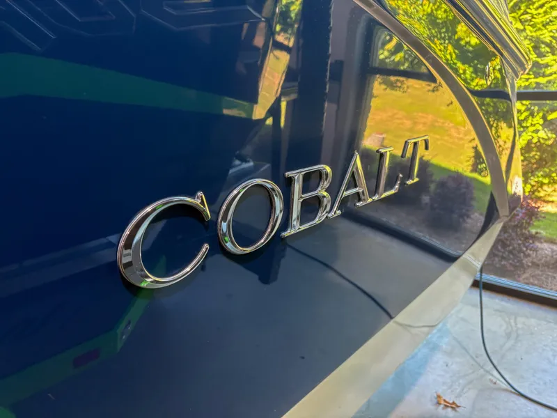 Slide: The Image of 2018 Cobalt R5 boat with reflective blue finish and chrome logo. - 8