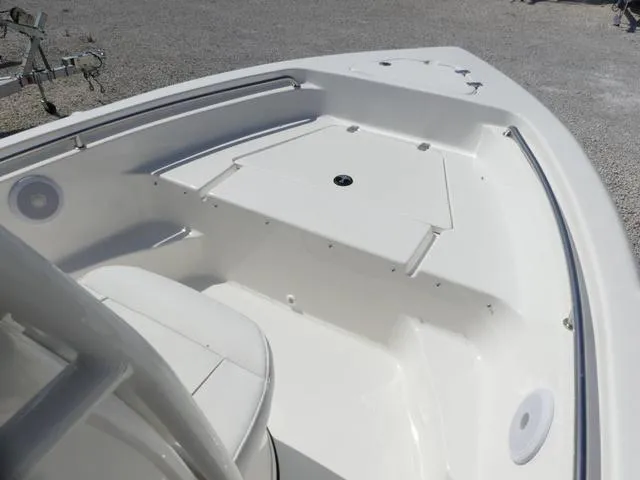 Slide: The Image of 2025 Key West 189 FS boat interior, featuring sleek white seating and storage compartments. - 11