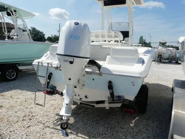 Slide: The Image of 2025 Key West 189 FS boat with outboard motor, parked on gravel lot. - 3