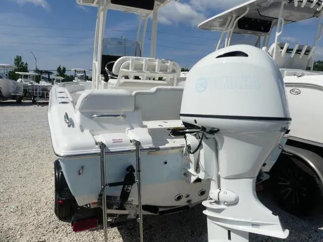 Slide: The Image of 2025 Key West 189 FS boat with Yamaha outboard motor, parked on gravel. - 4