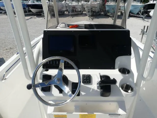 Slide: The Image of 2025 Key West 189 FS boat console with steering wheel and controls. - 6