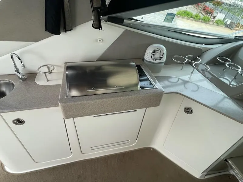 Slide: The Image of 2007 Sea Ray 310 Sundancer boat interior with kitchenette and stainless steel grill. - 10