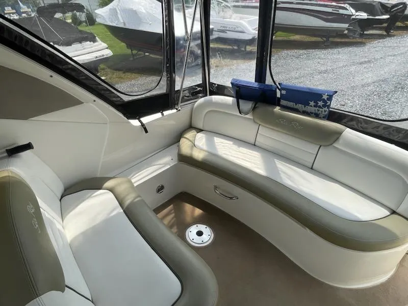 Slide: The Image of Interior of 2007 Sea Ray 310 Sundancer boat with cushioned seating and windows. - 14