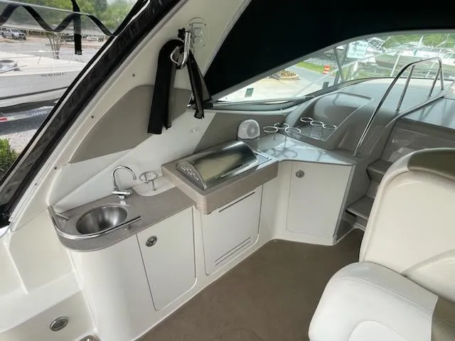 Slide: The Image of 2007 Sea Ray 310 Sundancer interior with kitchenette and seating area. - 20