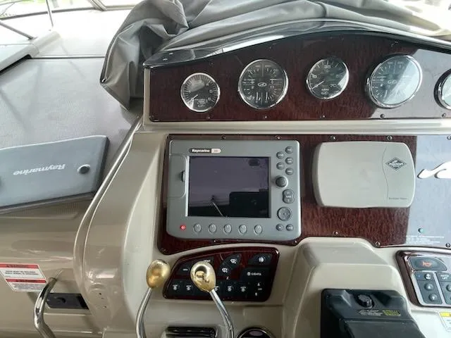 Slide: The Image of Dashboard of a 2007 Sea Ray 310 Sundancer boat with navigation controls and gauges. - 23