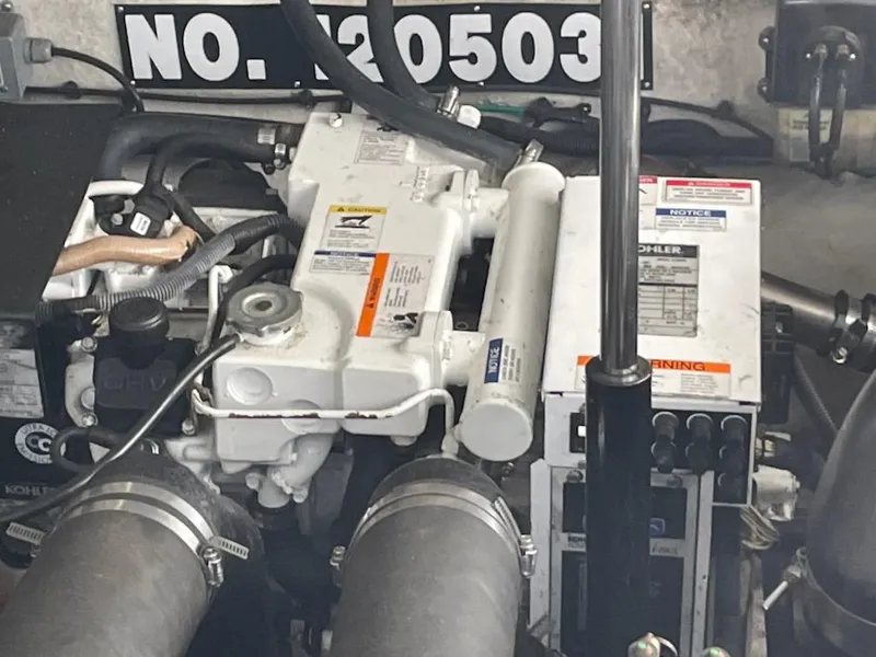 Slide: The Image of Engine compartment of a 2007 Sea Ray 310 Sundancer boat, featuring mechanical components. - 26