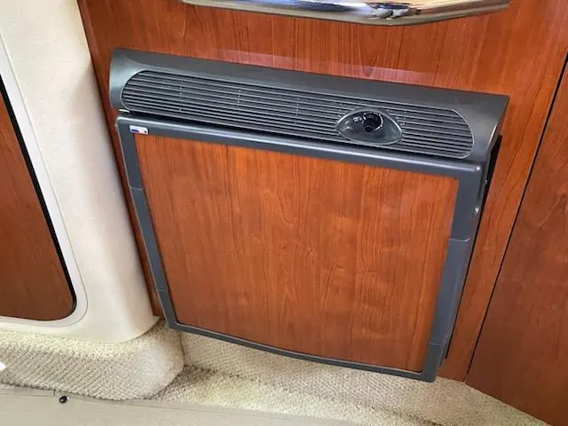 Slide: The Image of Wood-paneled mini fridge in 2007 Sea Ray 310 Sundancer yacht interior. - 32