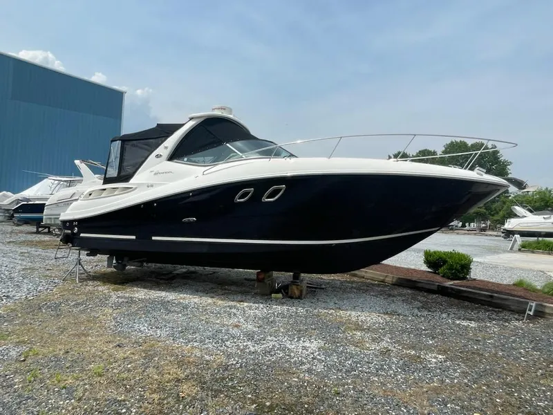 Slide: The Image of 2007 Sea Ray 310 Sundancer boat on display outdoors. - 6