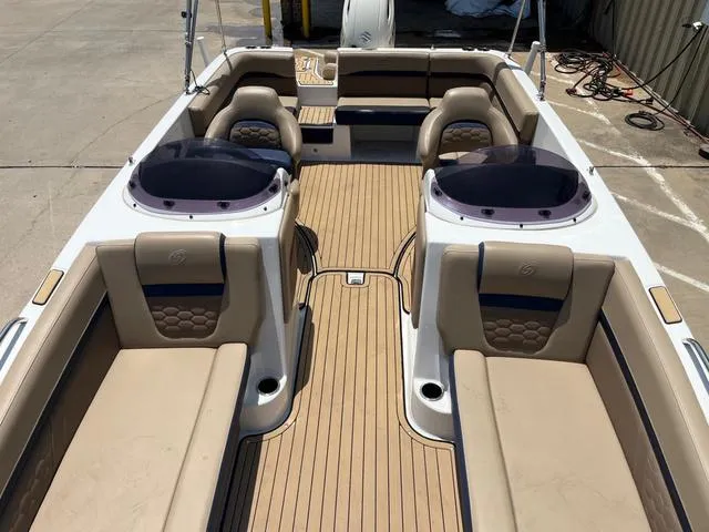Slide: The Image of 2020 Hurricane SS218 boat interior with beige seating and wood-style flooring. - 11