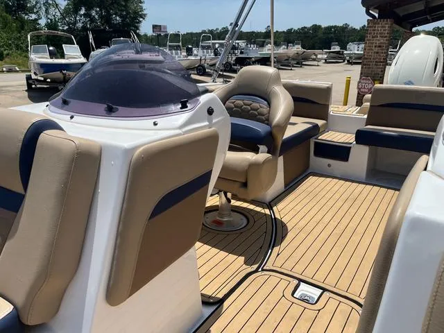 Slide: The Image of 2020 Hurricane SS218 boat interior with beige seating and wood-style flooring. - 12
