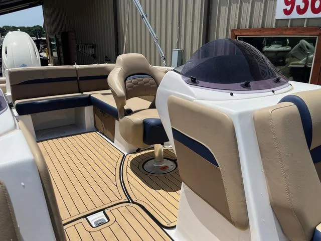 Slide: The Image of 2020 Hurricane SS218 boat interior with tan and blue seating, wood-style flooring. - 13