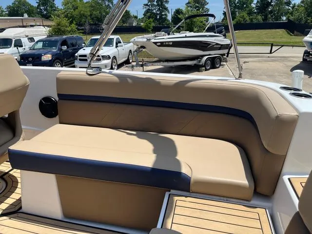 Slide: The Image of 2020 Hurricane SS218 boat interior with tan and navy seating, parked outdoors. - 14