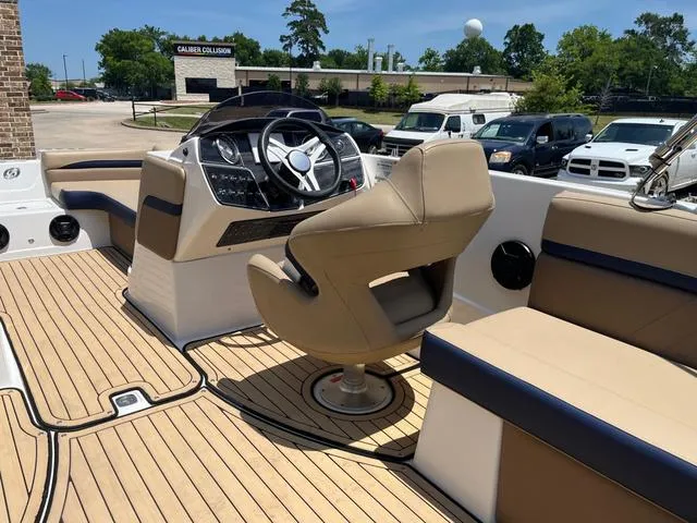 Slide: The Image of 2020 Hurricane SS218 boat interior with tan seating and modern steering console. - 15