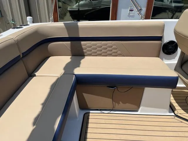Slide: The Image of 2020 Hurricane SS218 boat interior with beige and navy seating, wood flooring. - 16