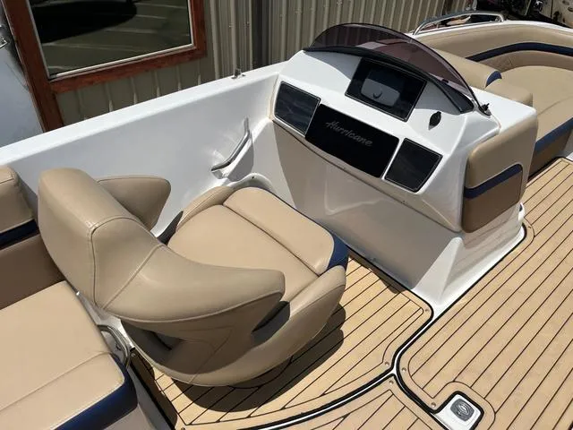 Slide: The Image of 2020 Hurricane SS218 boat interior with beige seating and modern dashboard. - 18