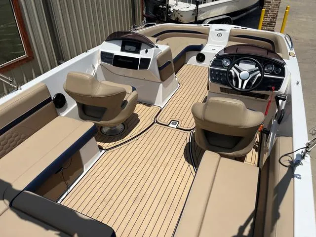 Slide: The Image of 2020 Hurricane SS218 boat interior with beige seating and modern dashboard. - 6