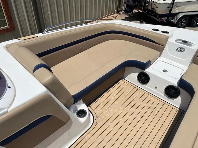 Slide: The Image of 2020 Hurricane SS218 boat interior with beige and blue seating, wood-style flooring. - 7