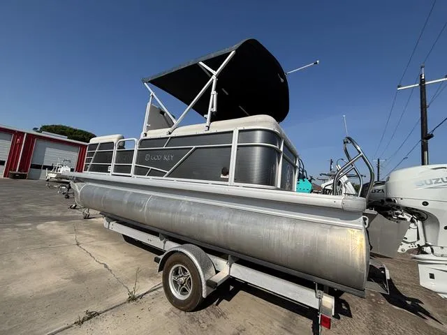Slide: The Image of 2023 Godfrey SW2080CX pontoon boat on trailer, parked outdoors under clear sky. - 1