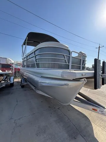 Slide: The Image of 2023 Godfrey SW2080CX pontoon boat on trailer under clear blue sky. - 2