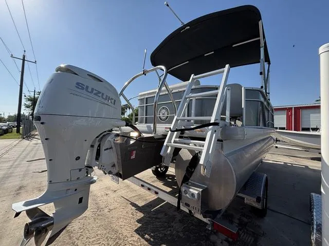Slide: The Image of 2023 Godfrey SW2080CX pontoon boat with Suzuki outboard motor, docked under clear sky. - 3