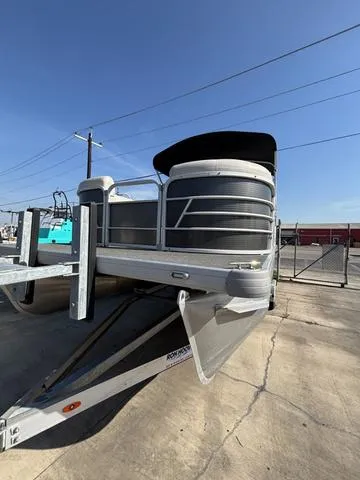 Slide: The Image of 2023 Godfrey SW2080CX pontoon boat on a trailer in a sunny outdoor setting. - 4