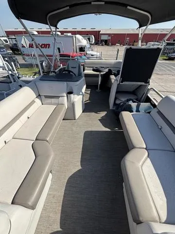 Slide: The Image of 2023 Godfrey SW2080CX pontoon boat interior with spacious seating and canopy. - 5