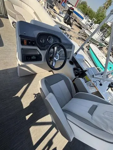 Slide: The Image of 2023 Godfrey SW2080CX boat interior with steering wheel and seating. - 6