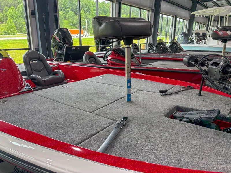 Slide: The Image of 2023 Falcon F185 boat interior with gray carpet and seating in a showroom. - 5