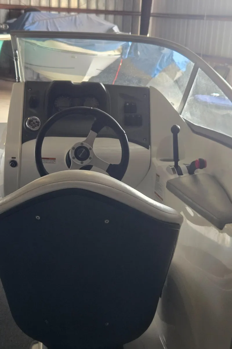 Slide: The Image of 2008 Sea-Doo 180 Challenger boat cockpit with steering wheel and controls. - 4