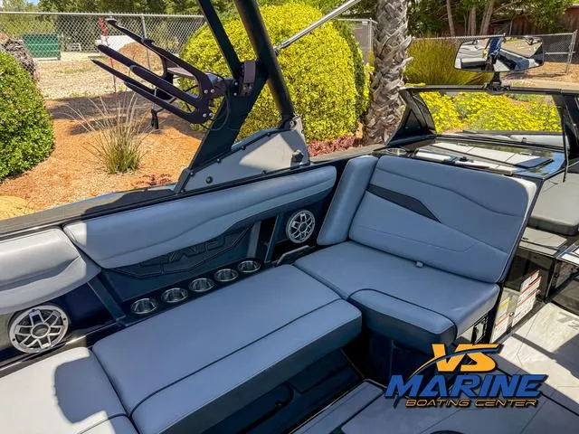 Slide: The Image of 2023 Axis Wake Research T250 boat interior with gray seating and speaker system. - 11