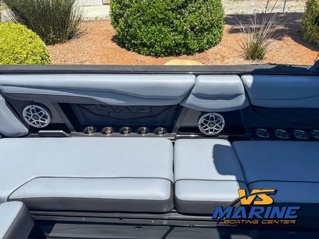 Slide: The Image of 2023 Axis Wake Research T250 boat interior with gray seating and speaker system. - 12