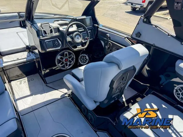 Slide: The Image of 2023 Axis Wake Research T250 boat interior with steering wheel and seating. - 15