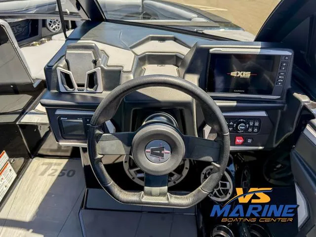 Slide: The Image of 2023 Axis T250 boat dashboard with steering wheel and Garmin display. - 17