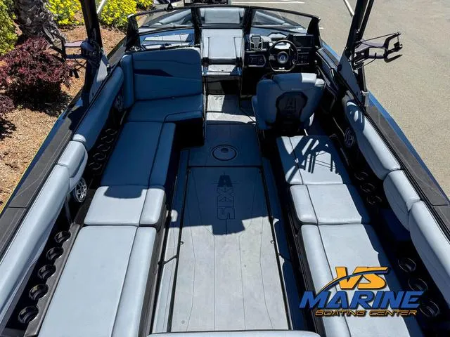 Slide: The Image of 2023 Axis Wake Research T250 boat interior with spacious seating and modern dashboard. - 9