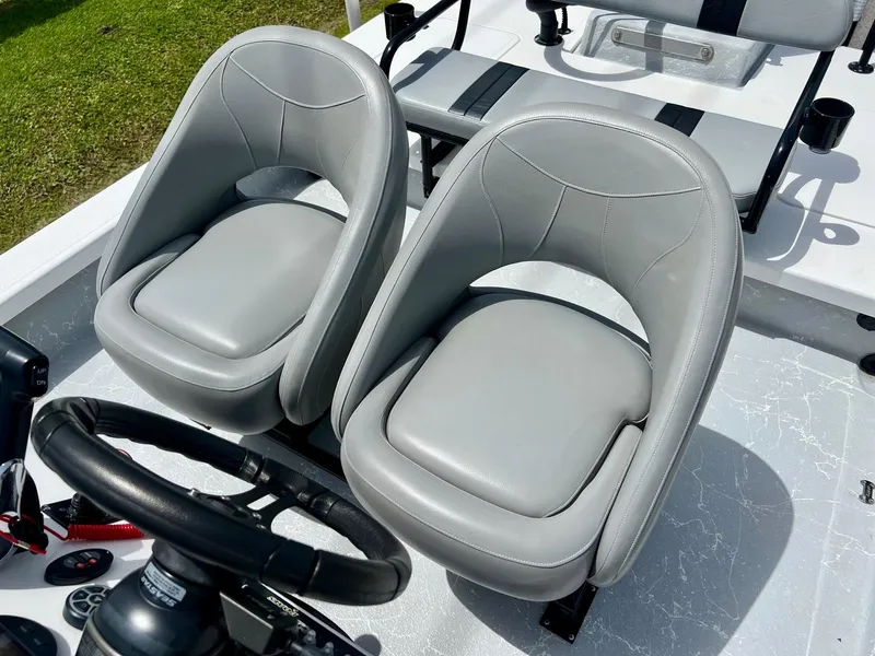 Slide: The Image of 2021 Majek REAPER boat with dual gray seats and steering wheel. - 10