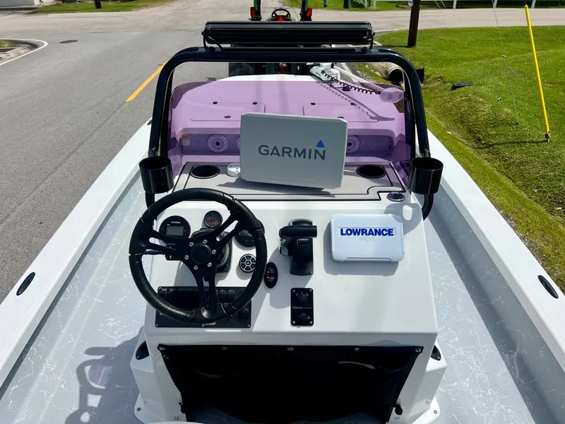 Slide: The Image of 2021 Majek REAPER boat dashboard with Garmin and Lowrance navigation systems. - 11