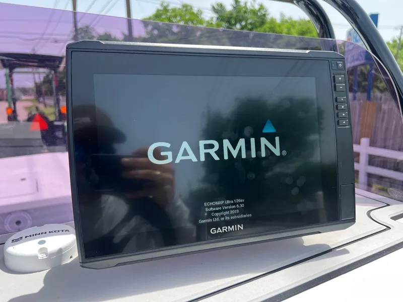 Slide: The Image of Garmin display on 2021 Majek REAPER boat dashboard, reflecting outdoor scenery. - 16