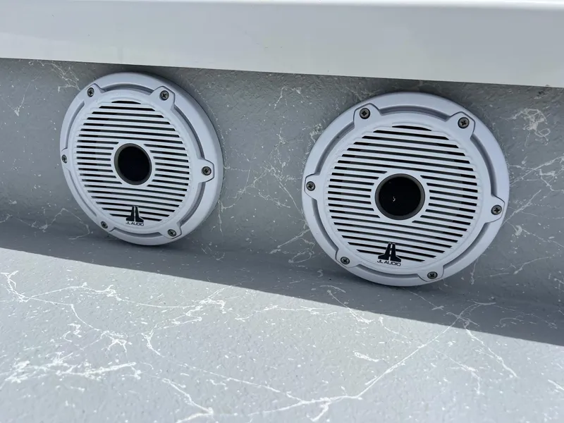Slide: The Image of White speakers on a Majek REAPER 2021 boat, mounted on a gray marbled surface. - 20