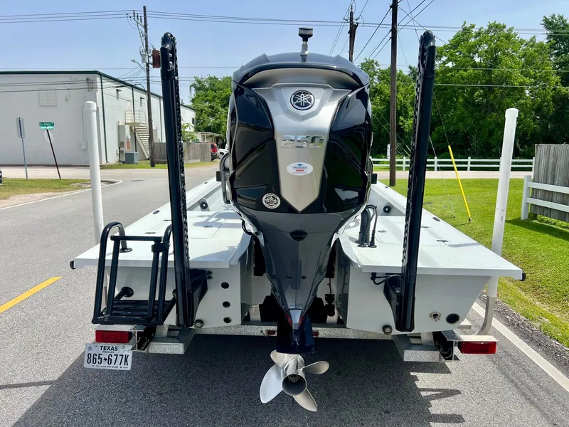 Slide: The Image of 2021 Majek REAPER boat on trailer, rear view with outboard motor, parked on street. - 3