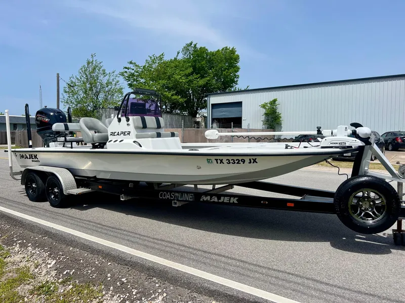 Slide: The Image of 2021 Majek REAPER boat on trailer, parked on roadside, with visible registration number. - 5