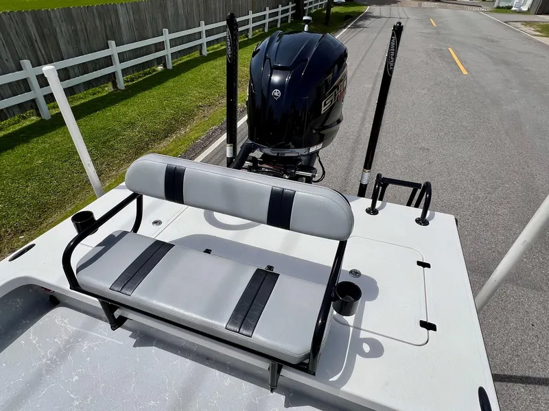 Slide: The Image of Majek REAPER 2021 boat with seating and motor, parked on a street. - 7