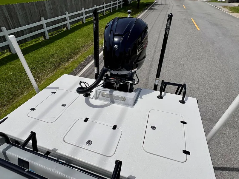 Slide: The Image of 2021 Majek REAPER boat with outboard motor on a road, featuring storage compartments. - 8