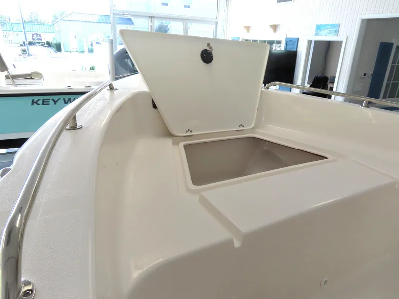 Slide: The Image of 2025 Key West 179 FS boat with open storage compartment in showroom. - 10